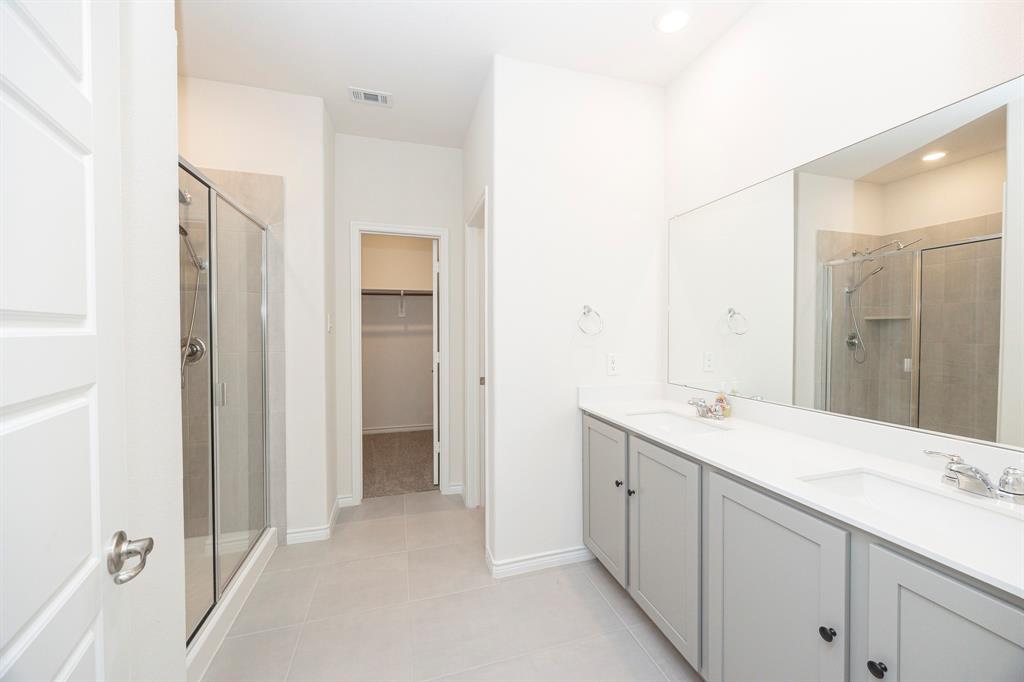 1001 Marigold Street Princeton, TX 75407 - Photo 20 of 37 a bathroom with a sink and a mirror