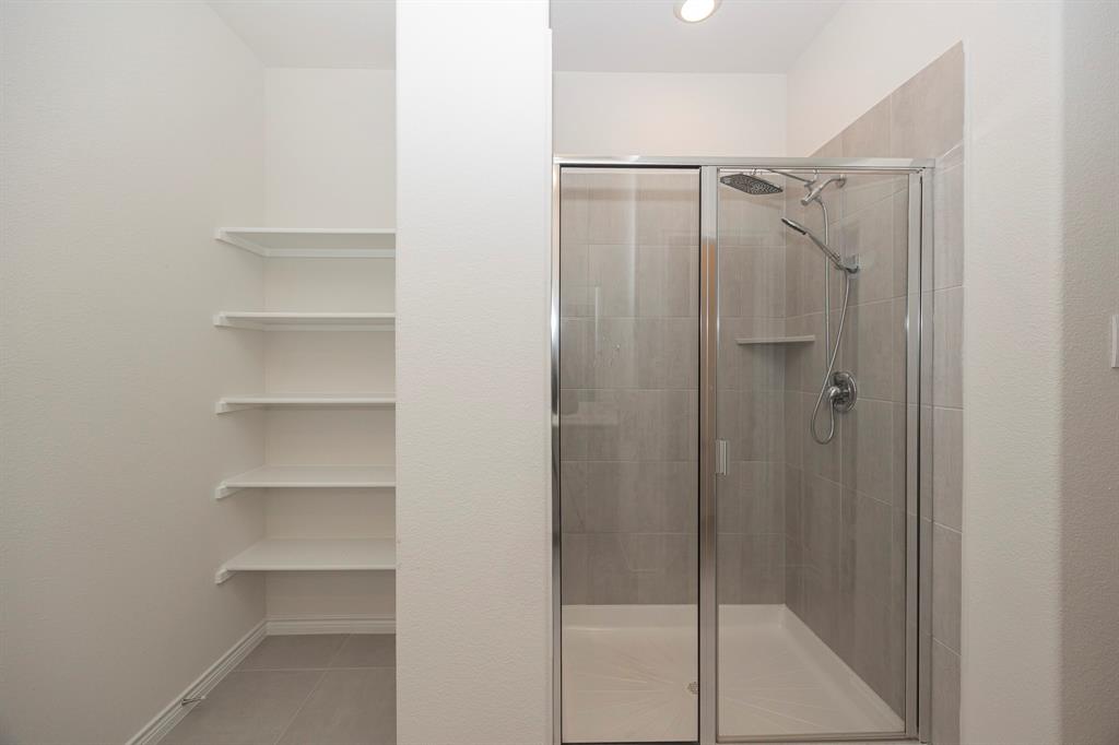 1001 Marigold Street Princeton, TX 75407 - Photo 22 of 37 a bathroom with a glass shower door