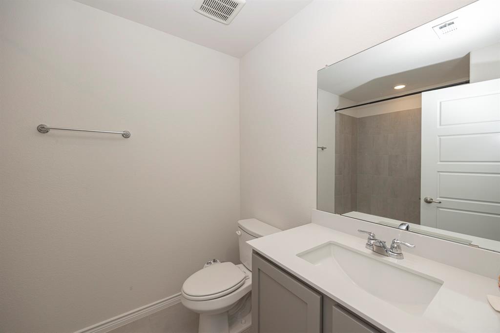 1001 Marigold Street Princeton, TX 75407 - Photo 30 of 37 a bathroom with a sink toilet and vanity