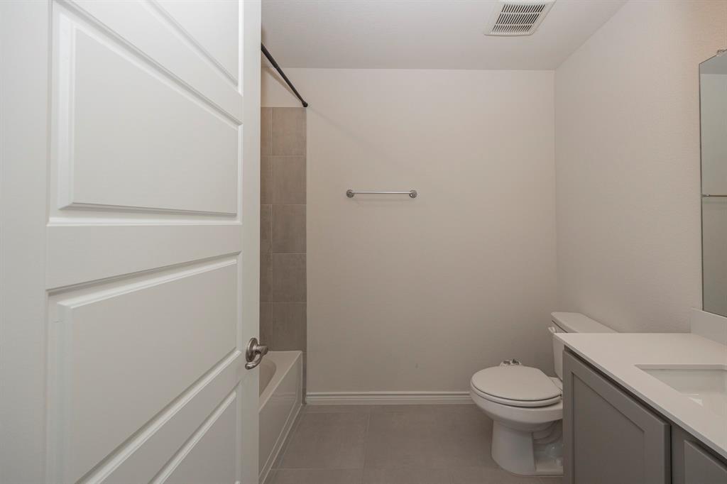 1001 Marigold Street Princeton, TX 75407 - Photo 31 of 37 a white toilet sitting next to a shower