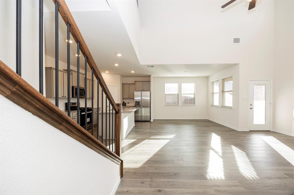 1001 Marigold Street Princeton, TX 75407 - Photo 4 of 37 a view of staircase with white walls and windows