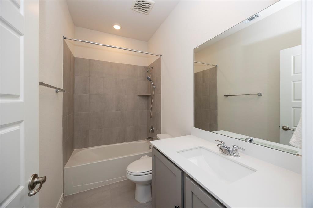 1001 Marigold Street Princeton, TX 75407 - Photo 7 of 37 a bathroom with a sink toilet vanity and shower