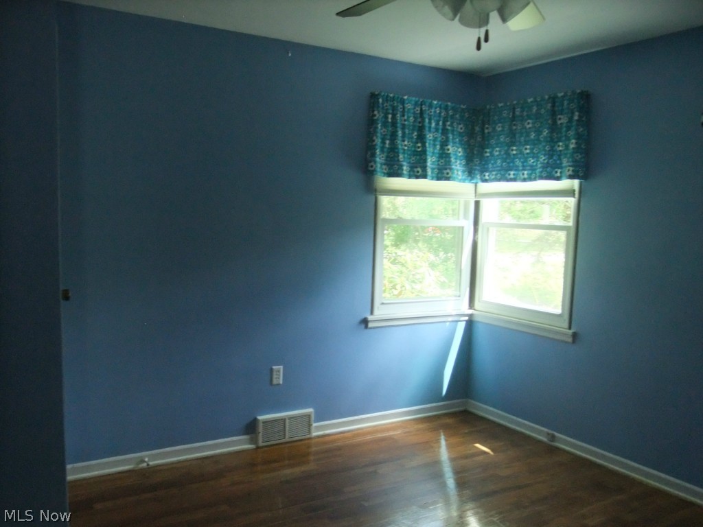 852 Brunsdorph Road Akron, OH 44333 - Photo 11 of 17 3rd bedroom also with corner windows. It has a ceiling fan and also hardwood floors.