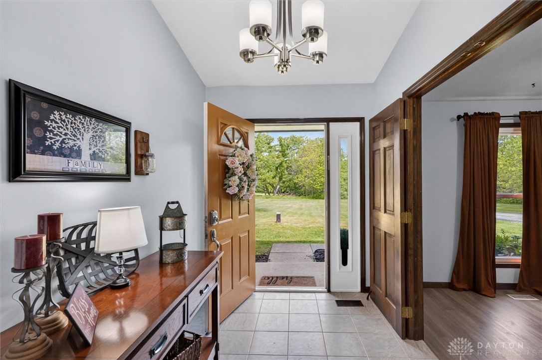2165 Stewart Road Xenia, OH 45385 - Photo 2 of 59 Step inside this inviting entry, offering a warm welcome and seamless flow to verdant outdoor spaces.