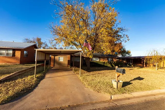 a view of a house with wooden fence