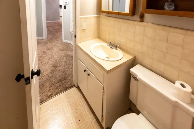a kitchen with appliances a sink and a refrigerator