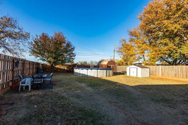 a view of a backyard with table and chairs