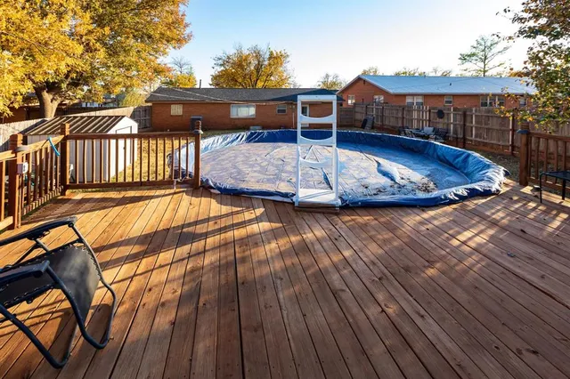 a view of house with swimming pool outdoor seating