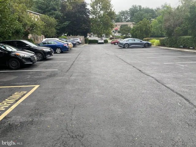 a view of cars parked on the side of a street