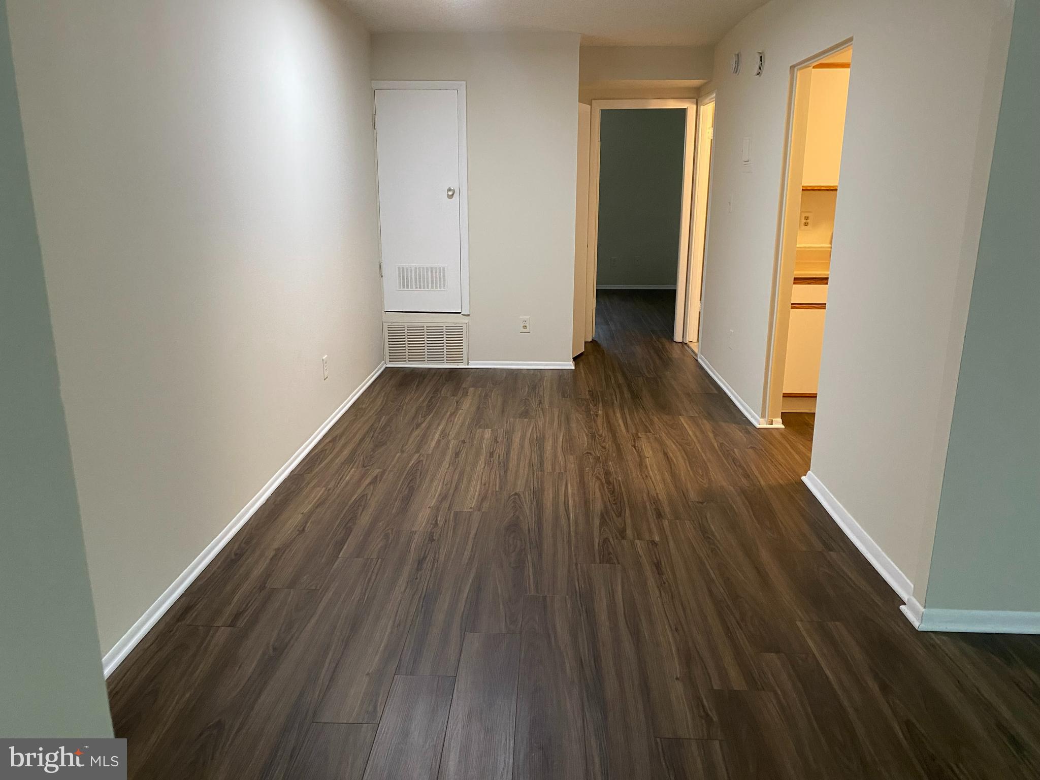 11914 J Tarragon Road, Unit J Reisterstown, MD 21136 - Photo 5 of 11 a view of a room with wooden floor and a window