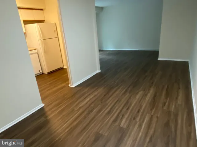 an empty room with wooden floor