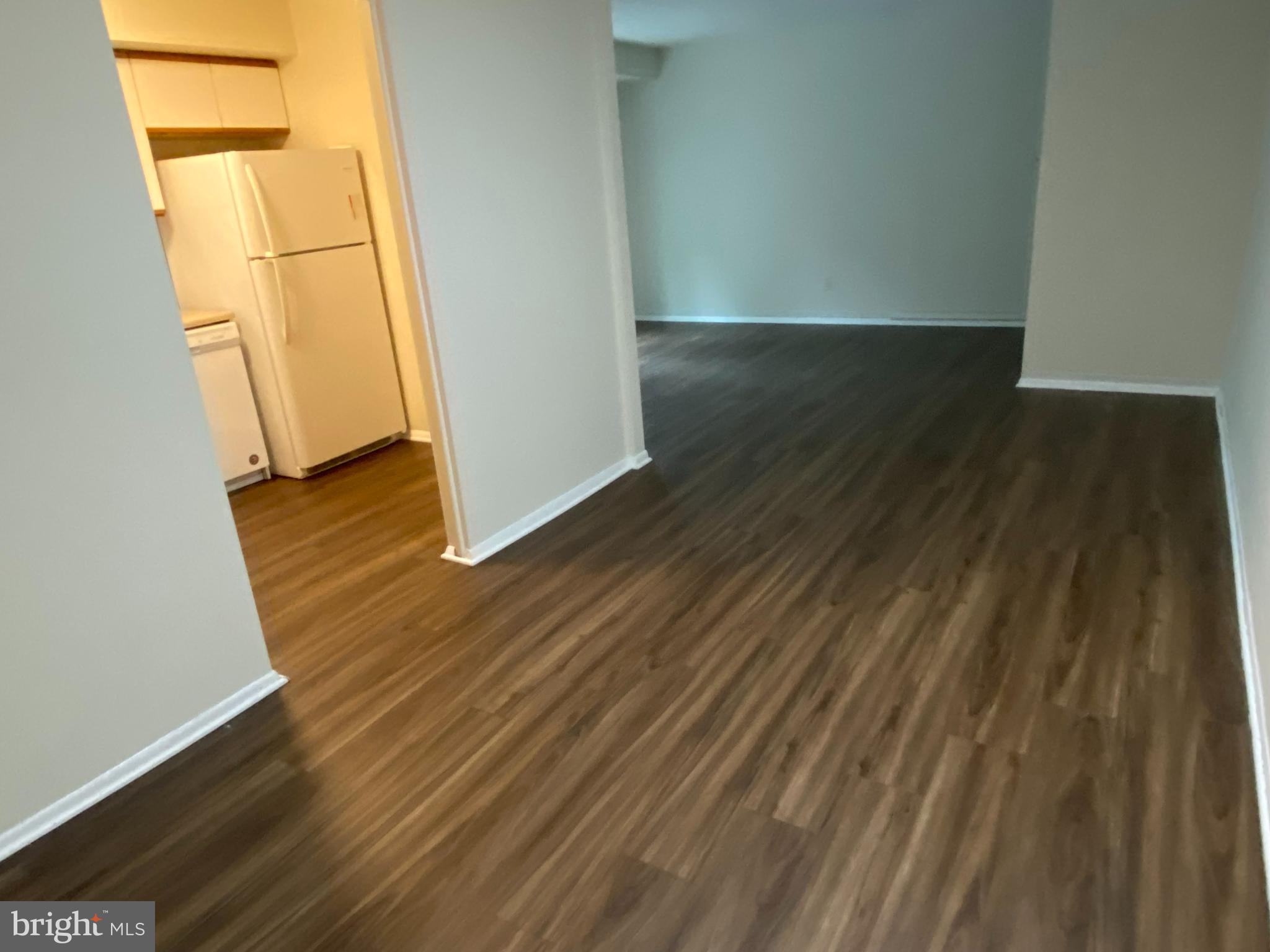 11914 J Tarragon Road, Unit J Reisterstown, MD 21136 - Photo 6 of 11 an empty room with wooden floor