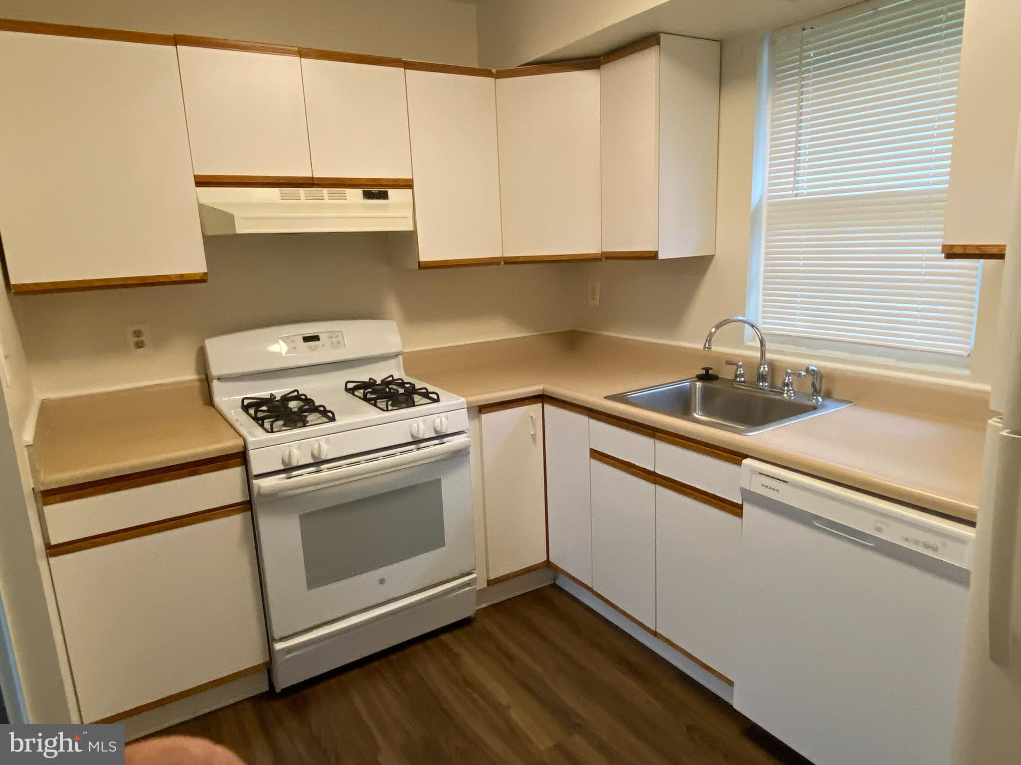 11914 J Tarragon Road, Unit J Reisterstown, MD 21136 - Photo 8 of 11 a kitchen with a sink stove and cabinets