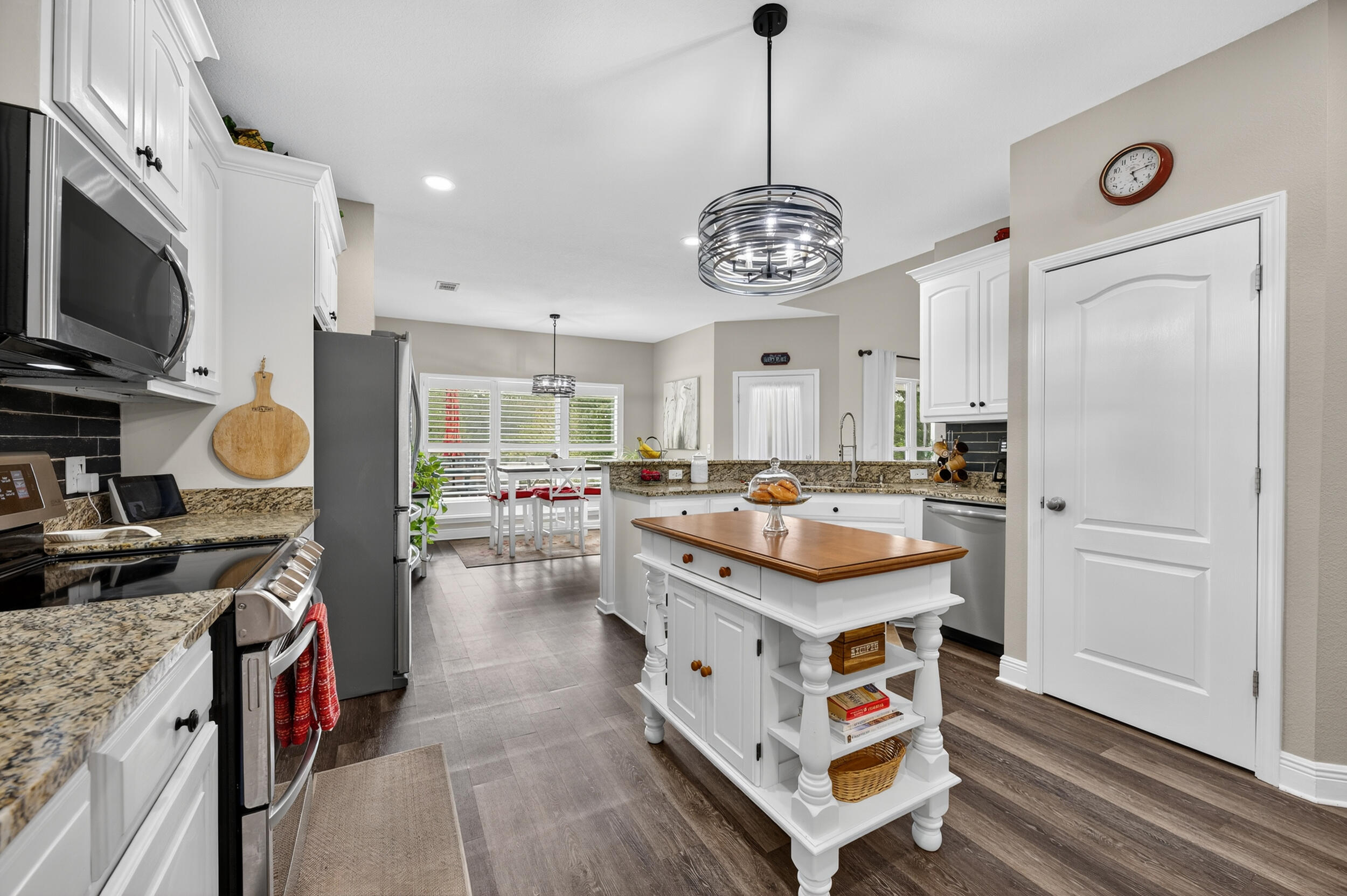 4036 Lakeview Drive Crestview, FL 32539 - Photo 12 of 45 a kitchen with a stove a refrigerator and a fireplace