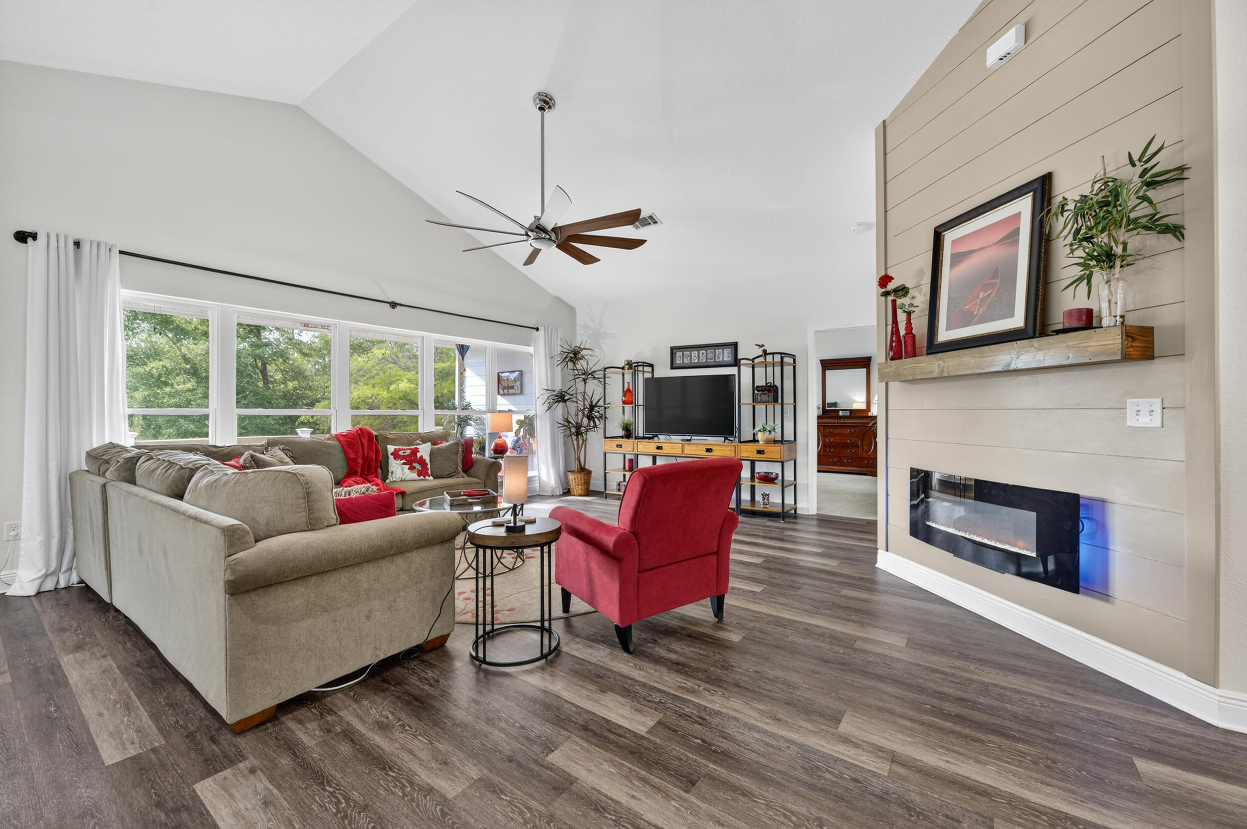 4036 Lakeview Drive Crestview, FL 32539 - Photo 14 of 45 a living room with furniture a fireplace and a flat screen tv