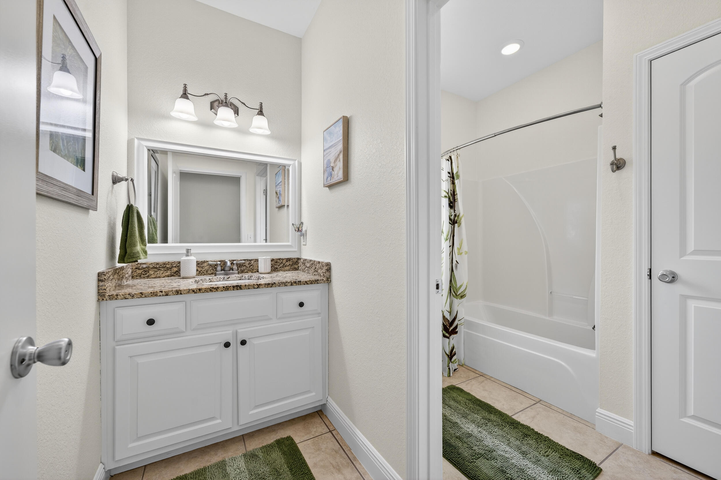 4036 Lakeview Drive Crestview, FL 32539 - Photo 19 of 45 a bathroom with a sink a mirror a vanity and a shower