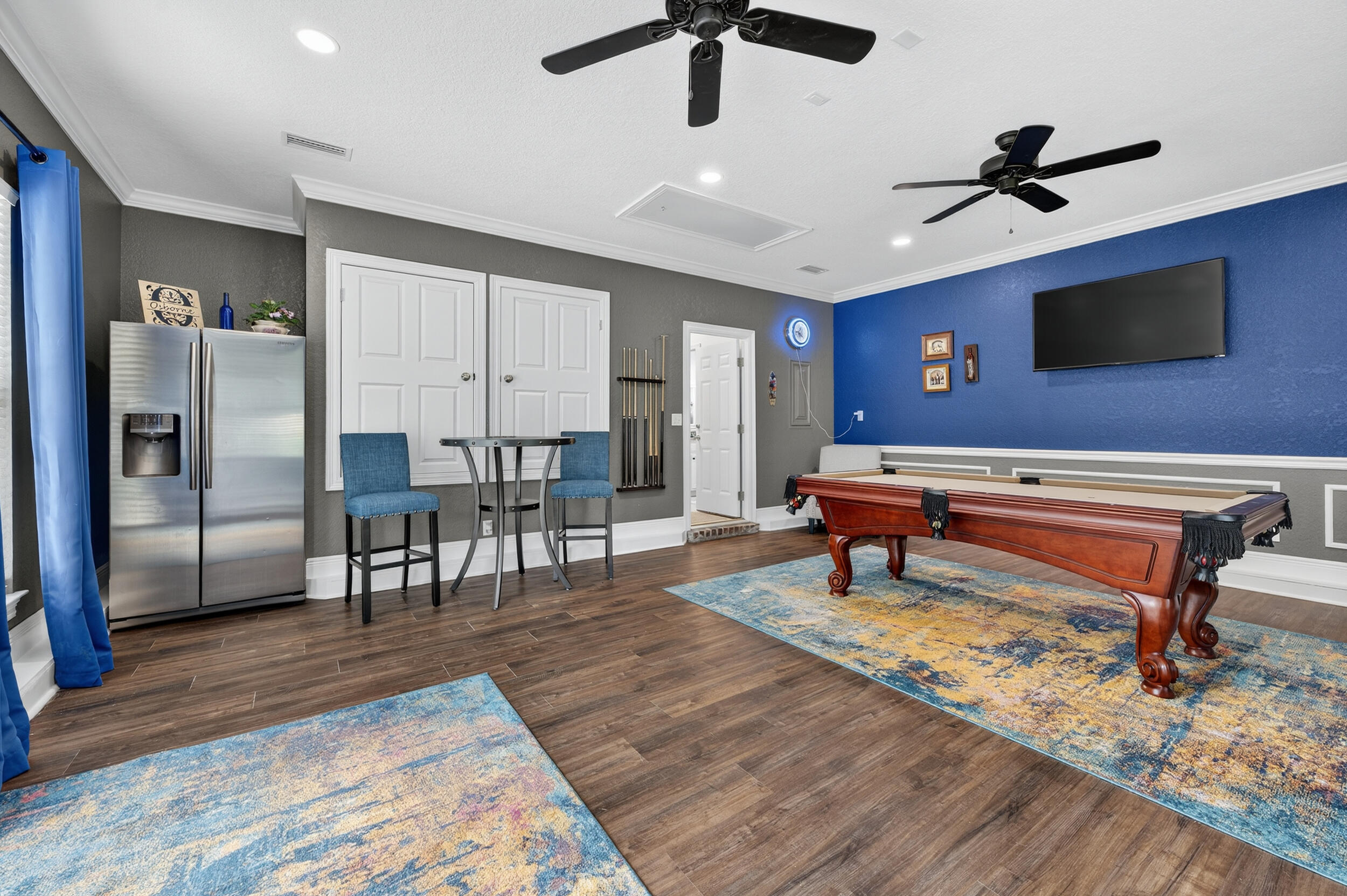 4036 Lakeview Drive Crestview, FL 32539 - Photo 27 of 45 a living room with furniture a flat screen tv and kitchen view