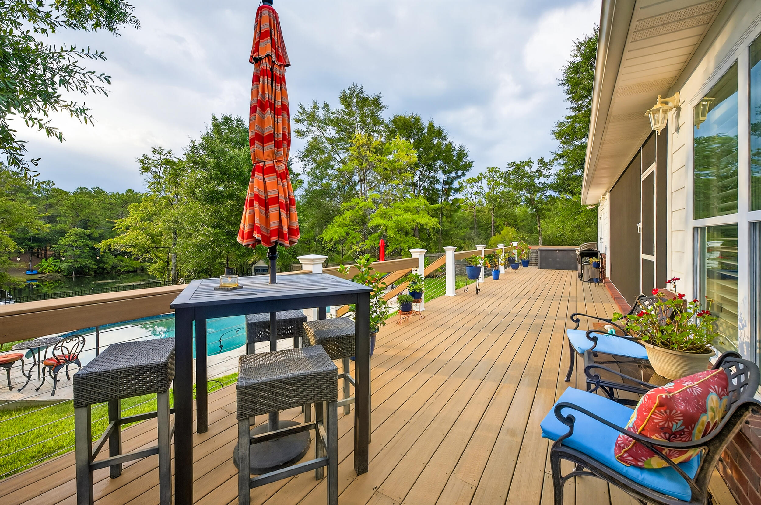 4036 Lakeview Drive Crestview, FL 32539 - Photo 36 of 45 a view of a patio with table and chairs potted plants with wooden floor and fence
