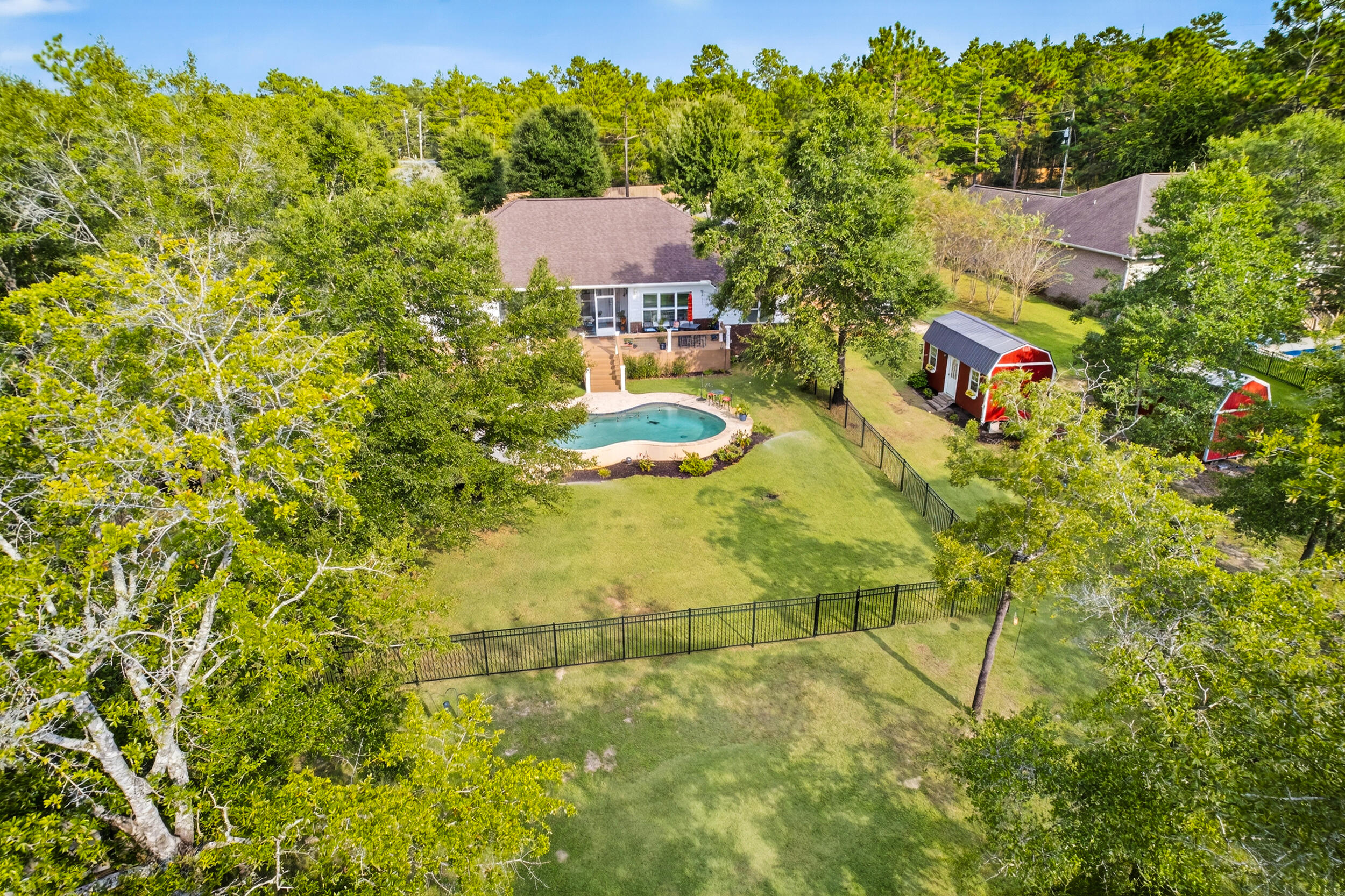 4036 Lakeview Drive Crestview, FL 32539 - Photo 41 of 45 a aerial view of a house with swimming pool and large trees