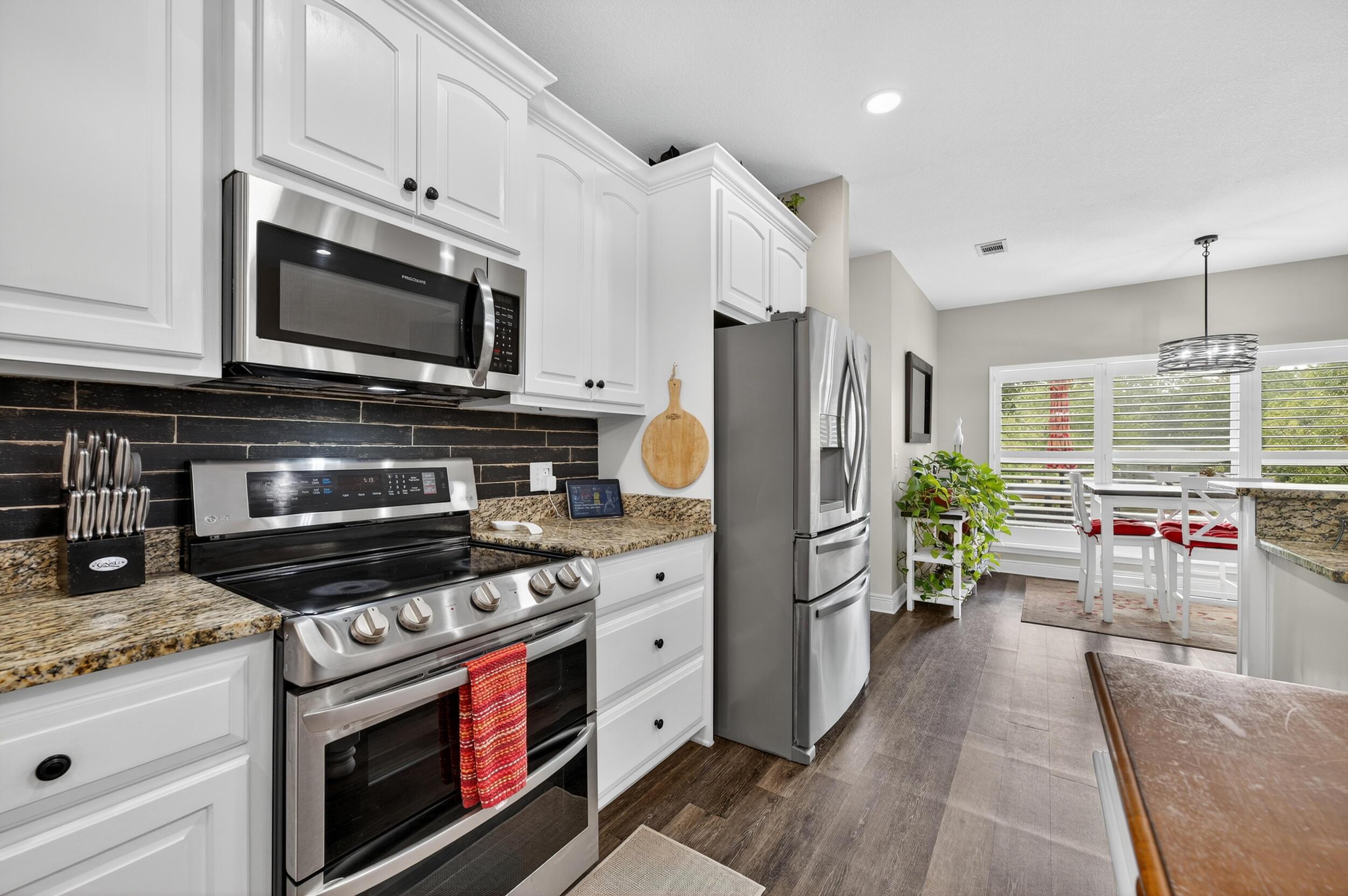 4036 Lakeview Drive Crestview, FL 32539 - Photo 8 of 45 a kitchen with stainless steel appliances a stove a sink and a microwave