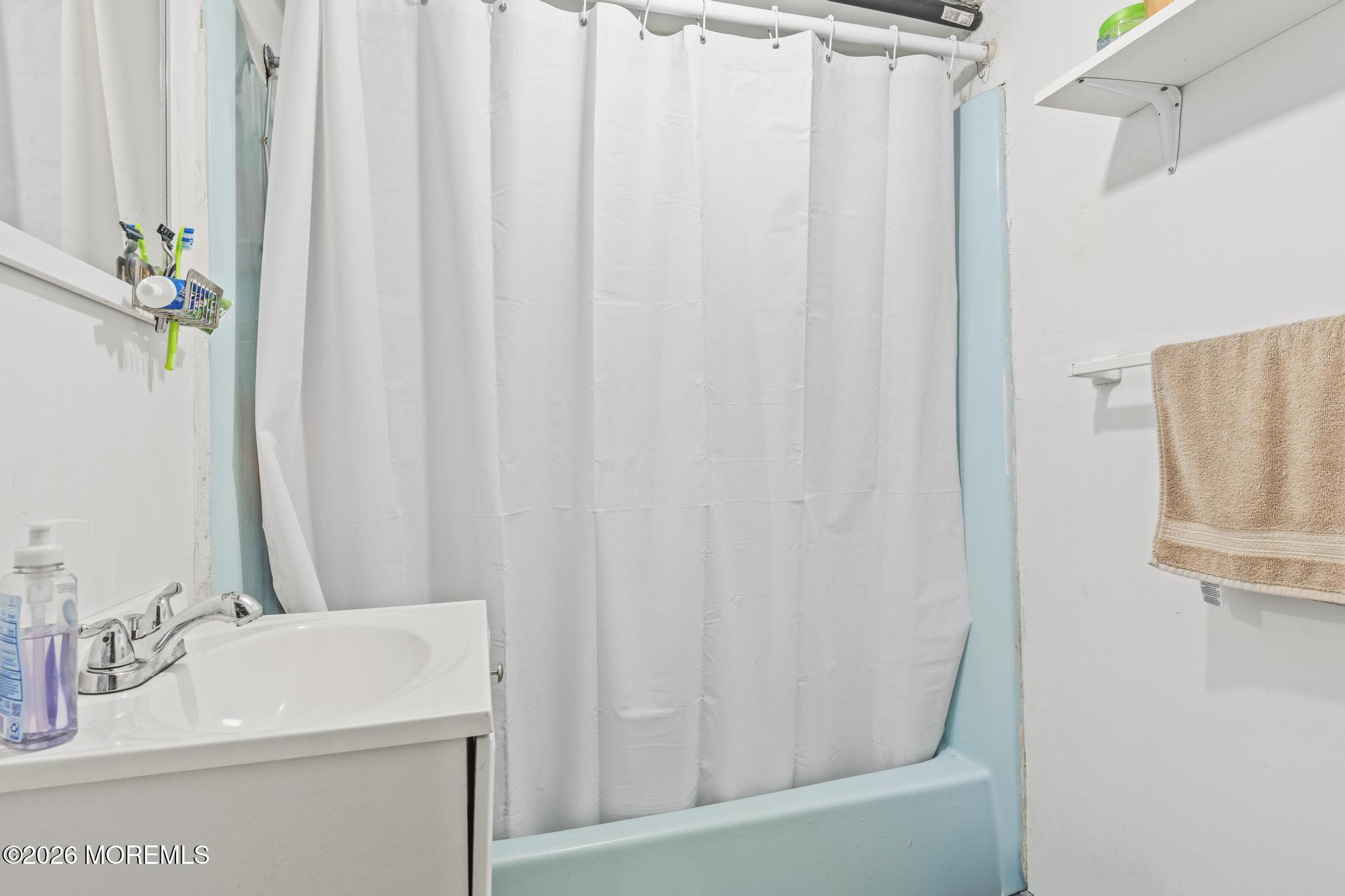 1914 Rutherford Avenue Neptune Township, NJ 07753 - Photo 19 of 25 a bathroom with a sink a mirror and a shower