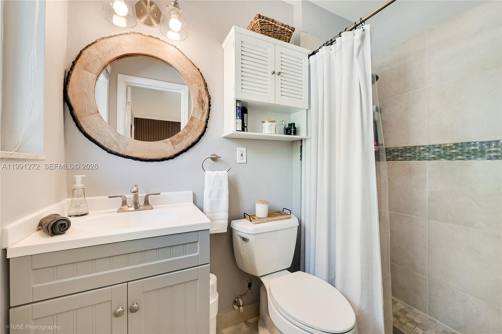 8535 Southwest 97th Road Miami, FL 33173 - Photo 13 of 28 a bathroom with a toilet a sink and a mirror