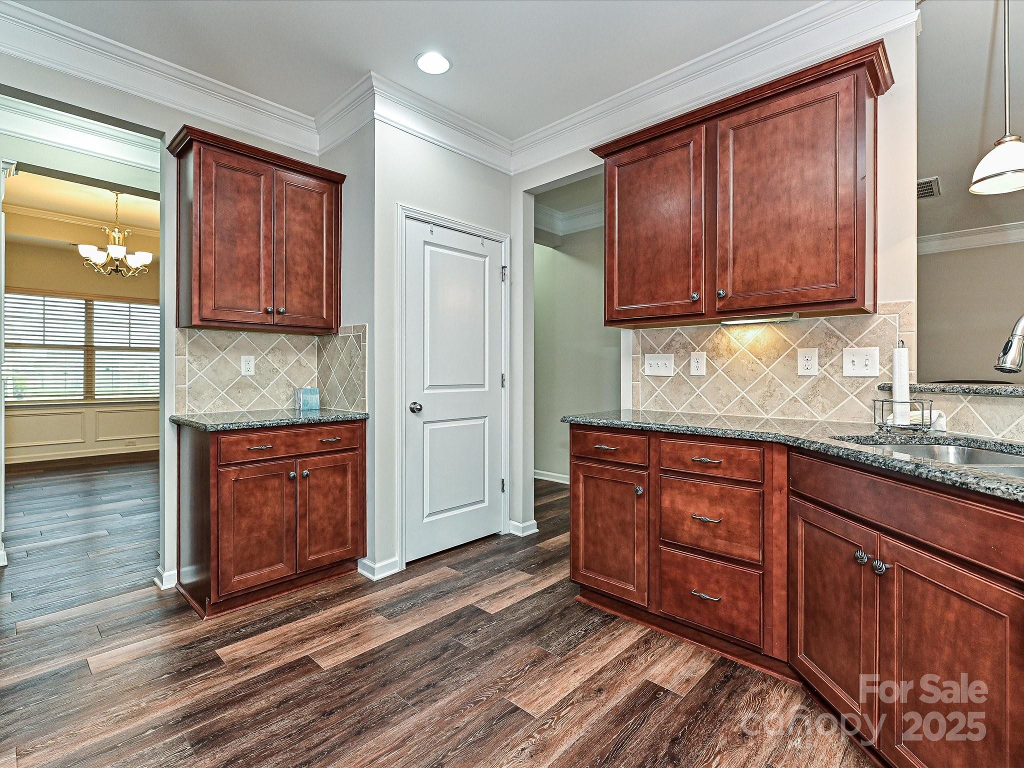 4425 Marlay Park Indian Trail, NC 28079 - Photo 11 of 33 a kitchen with granite countertop wooden cabinets stainless steel appliances a sink and a window