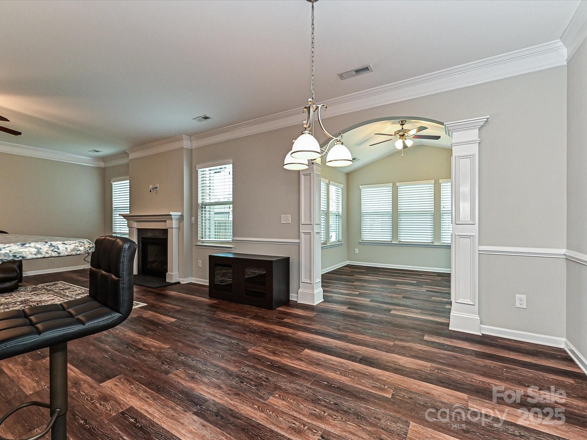 4425 Marlay Park Indian Trail, NC 28079 - Photo 14 of 33 a view of a livingroom with a fireplace a chandelier and wooden floor