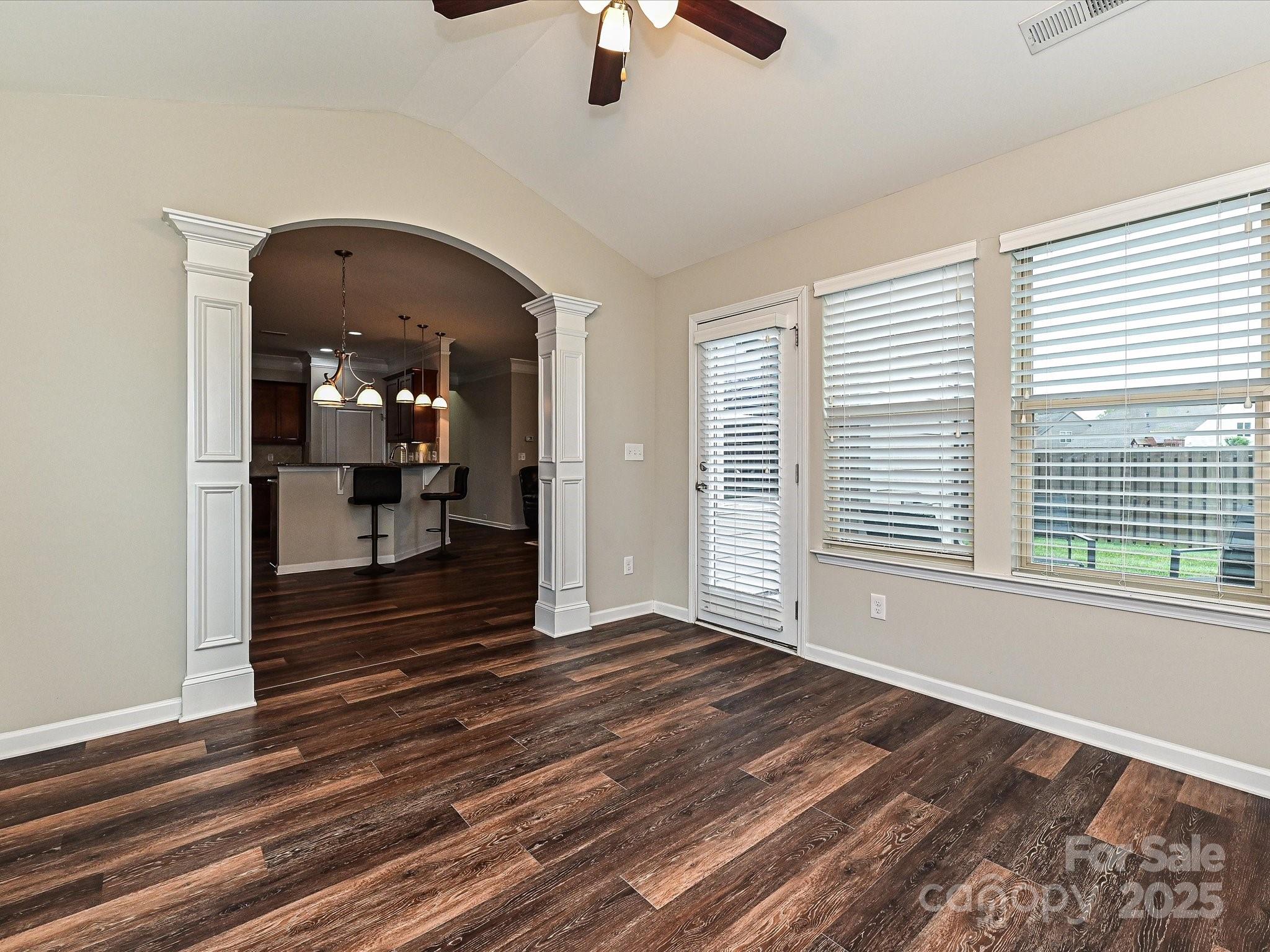 4425 Marlay Park Indian Trail, NC 28079 - Photo 20 of 33 a view of a livingroom with wooden floor a ceiling fan and windows