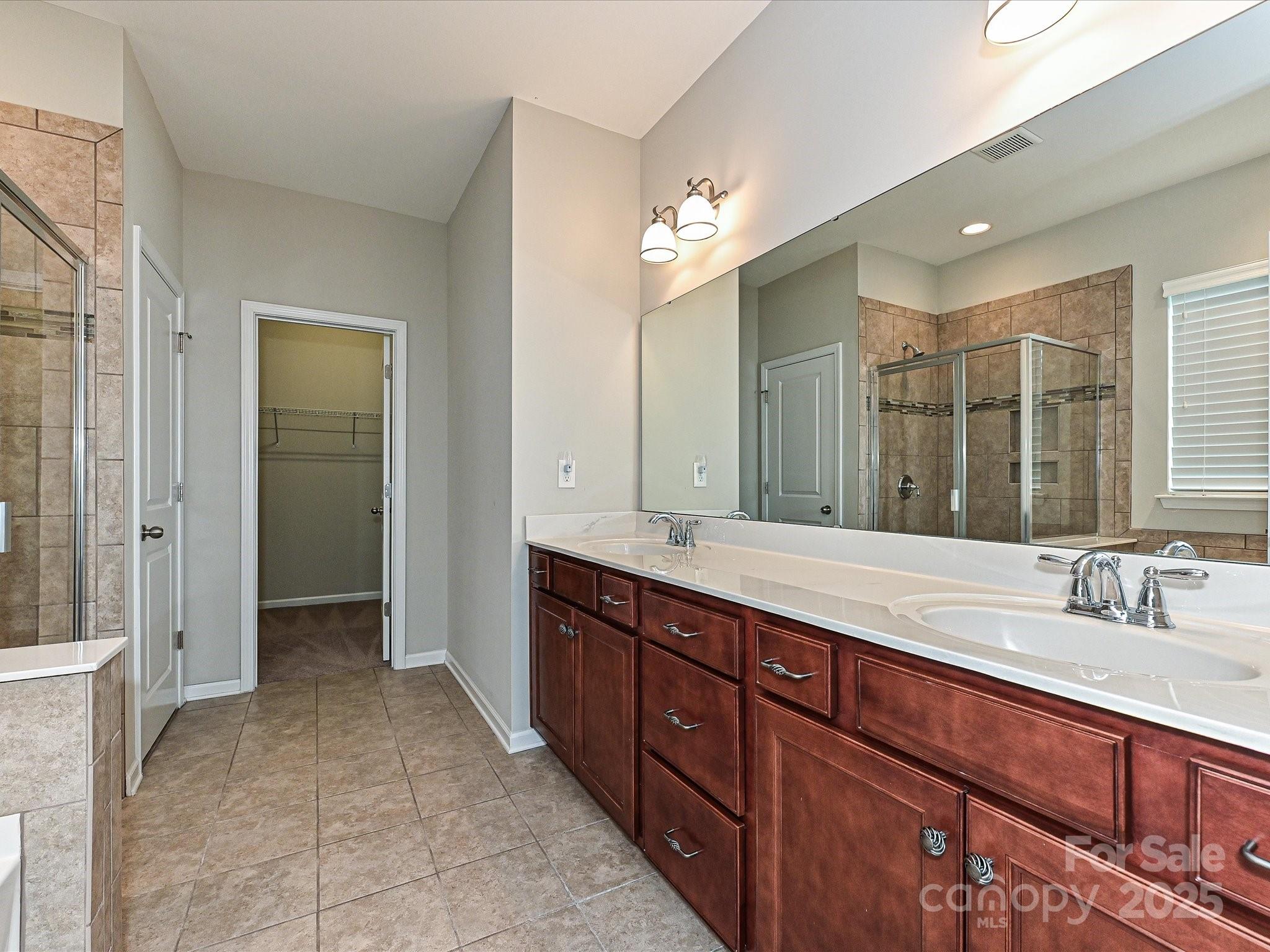 4425 Marlay Park Indian Trail, NC 28079 - Photo 23 of 33 a spacious bathroom with a double vanity sink a large mirror and a shower