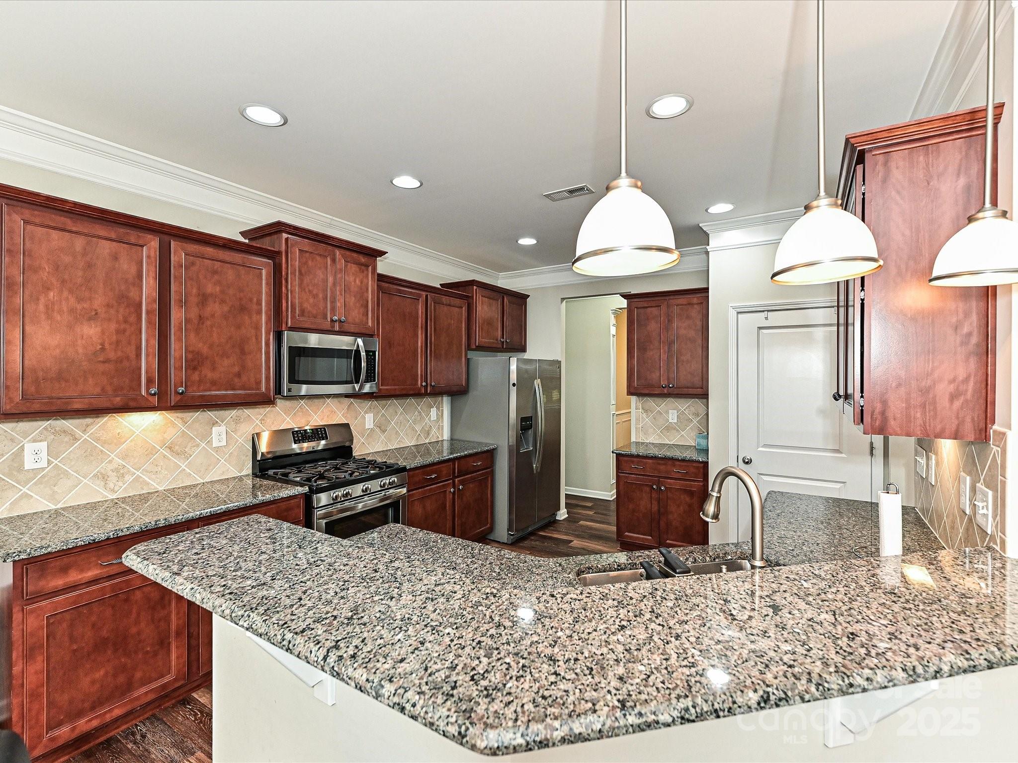4425 Marlay Park Indian Trail, NC 28079 - Photo 9 of 33 a kitchen with stainless steel appliances granite countertop a sink stove and refrigerator