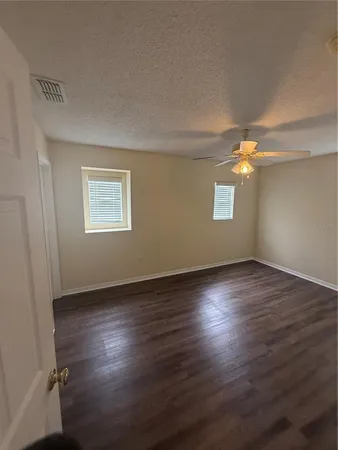 a view of an empty room and a window