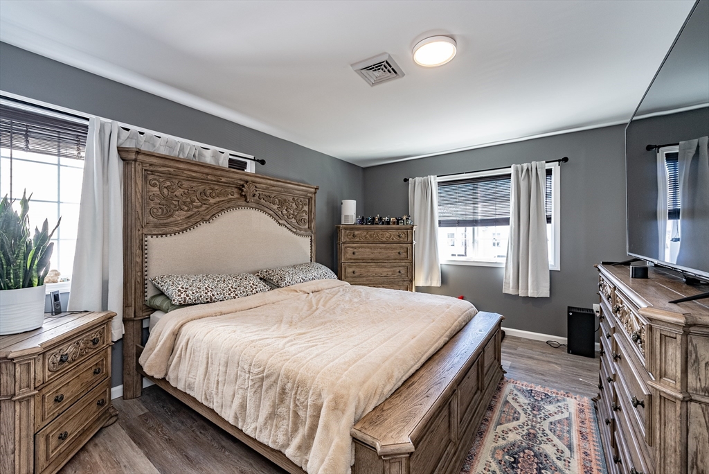 42 Ringgold Street Springfield, MA 01107 - Photo 11 of 13 a bedroom with a bed and a dresser with mirror