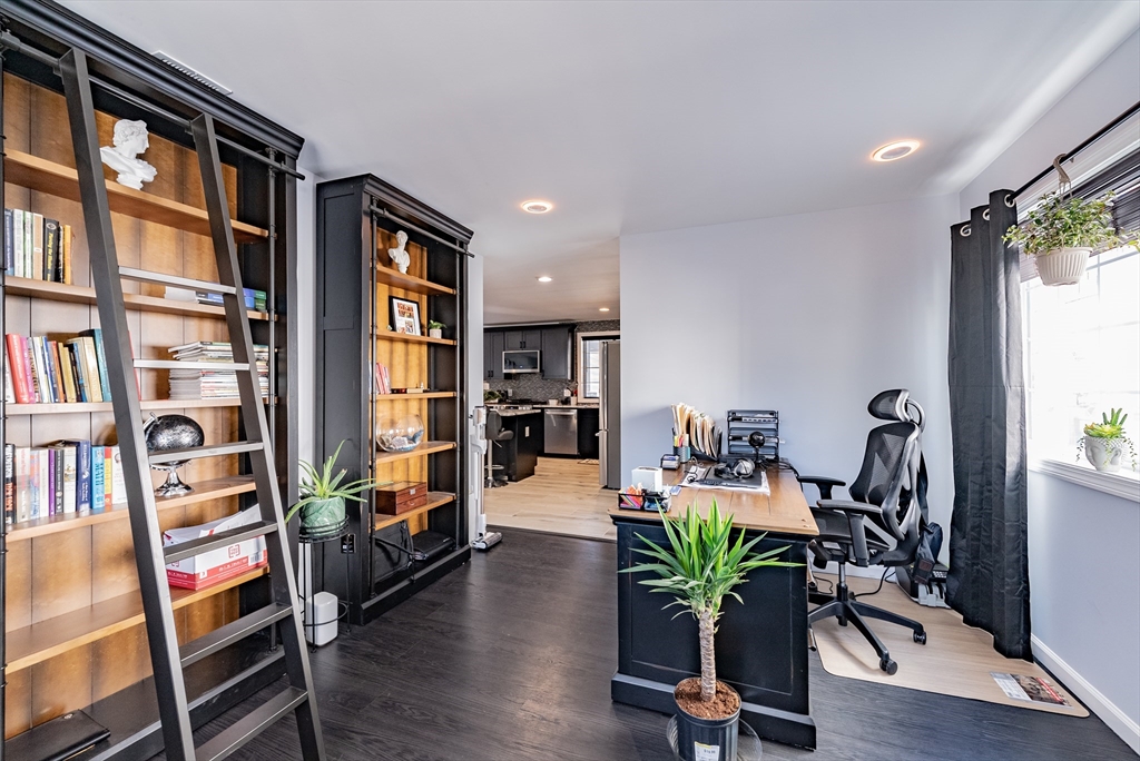 42 Ringgold Street Springfield, MA 01107 - Photo 4 of 13 a view of a livingroom with furniture and a bookshelf
