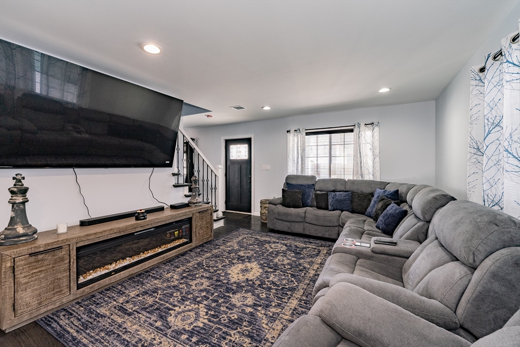 42 Ringgold Street Springfield, MA 01107 - Photo 6 of 13 a living room with furniture a flat screen tv and kitchen view
