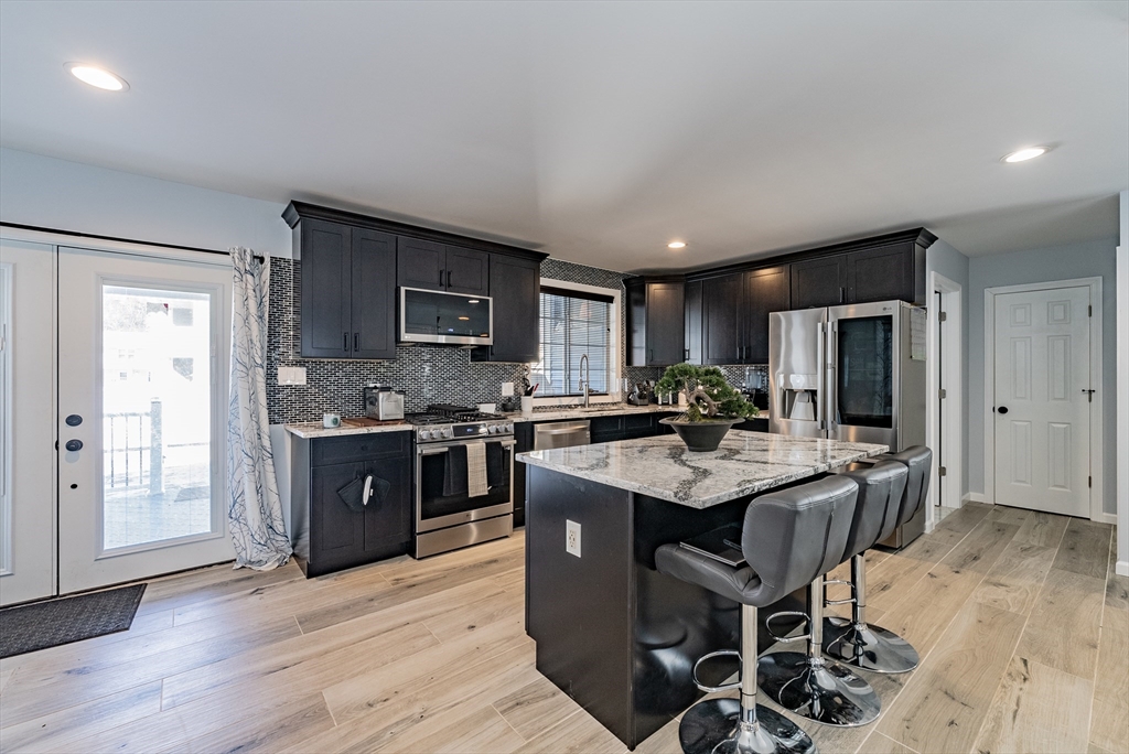 42 Ringgold Street Springfield, MA 01107 - Photo 7 of 13 a kitchen with granite countertop stainless steel appliances stove microwave and cabinets