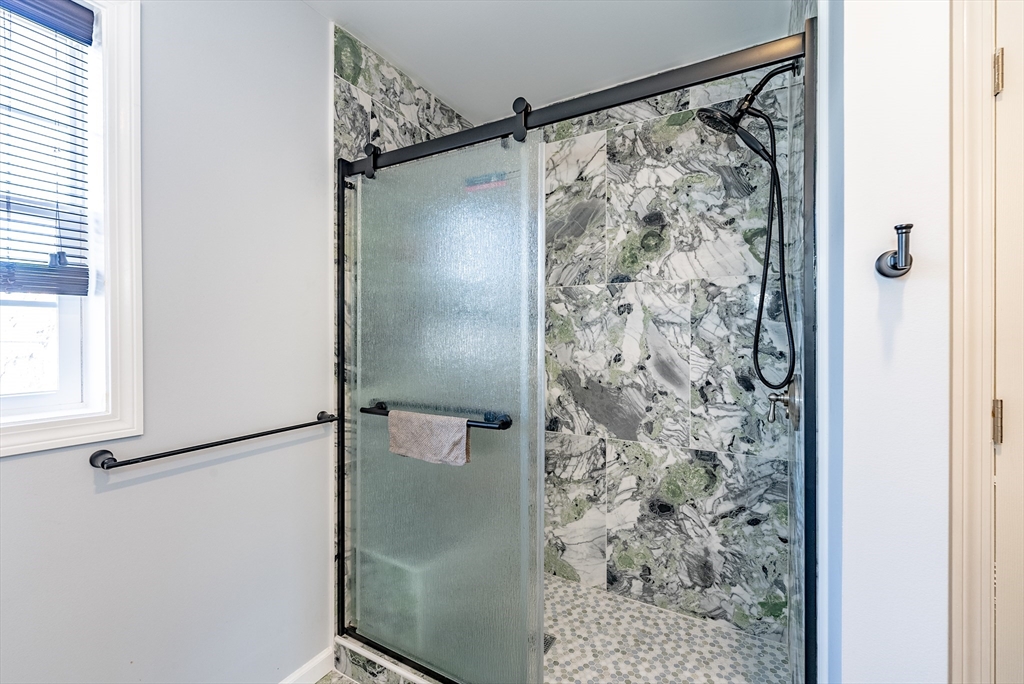 42 Ringgold Street Springfield, MA 01107 - Photo 10 of 13 a bathroom with a shower and a glass door