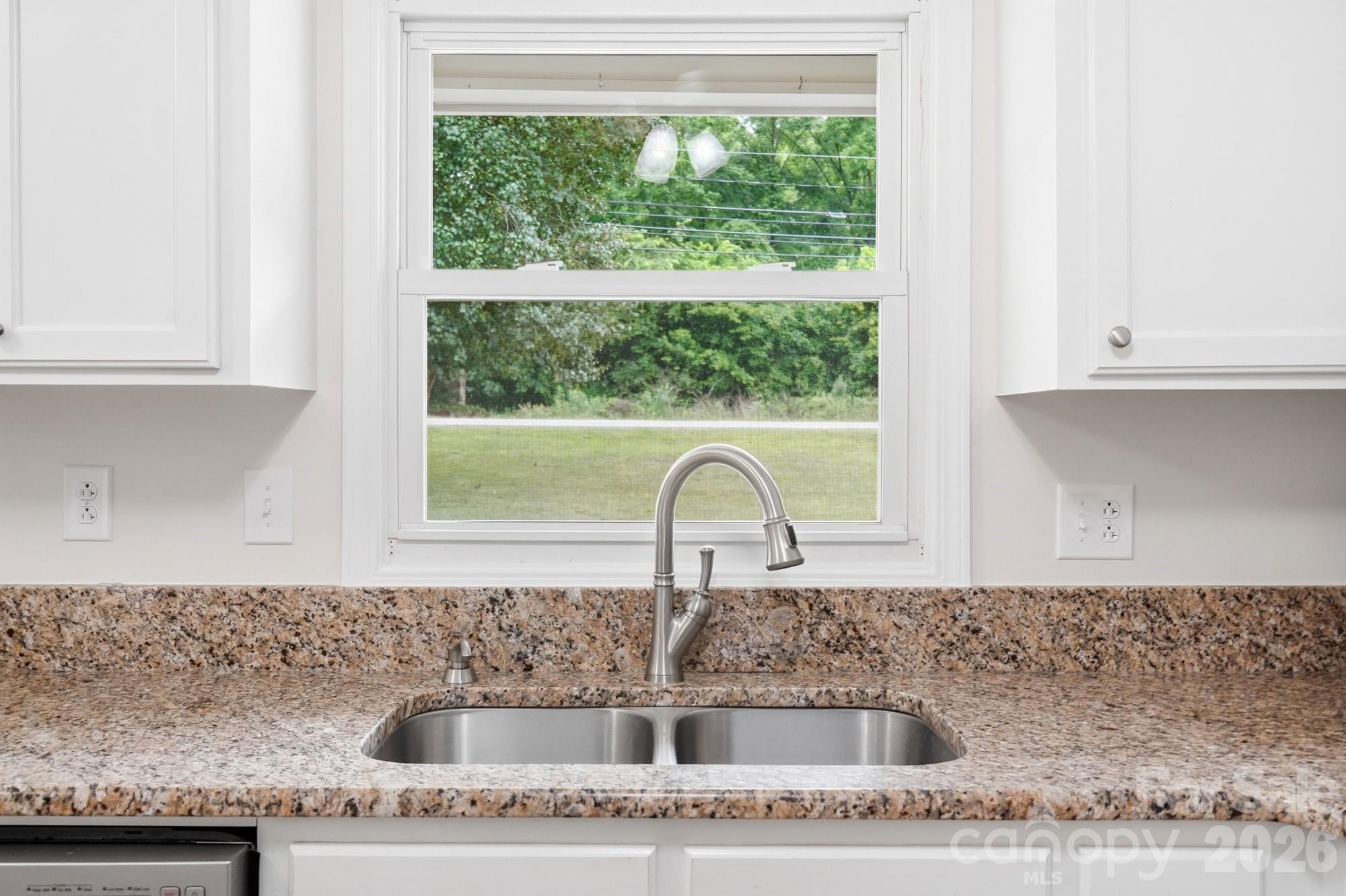 1235 Winecoff School Road Concord, NC 28027 - Photo 9 of 27 a kitchen with granite countertop a sink and a window