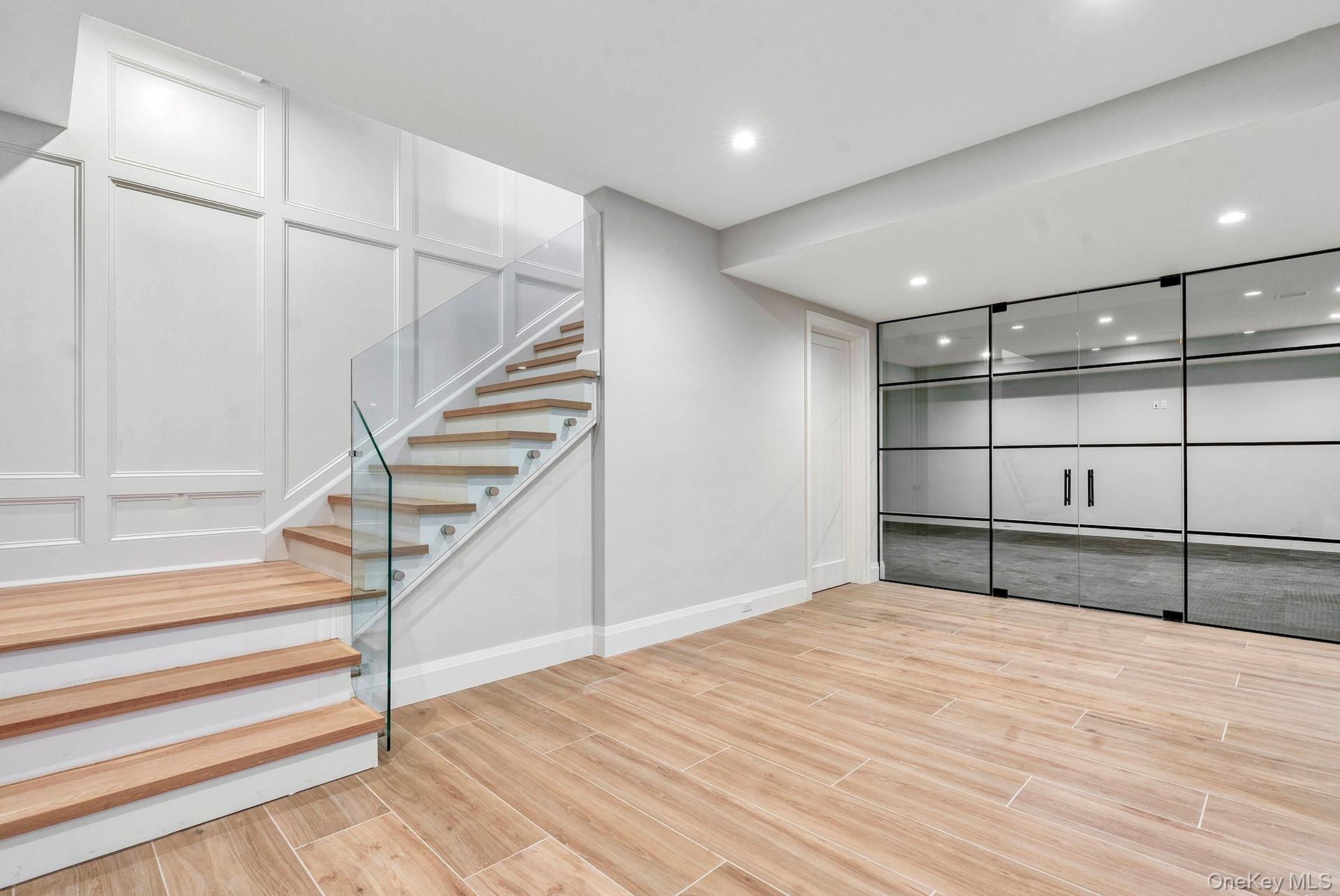 2524 Noyack Road Sag Harbor, NY 11963 - Photo 27 of 38 a view of a room with wooden floor and staircase