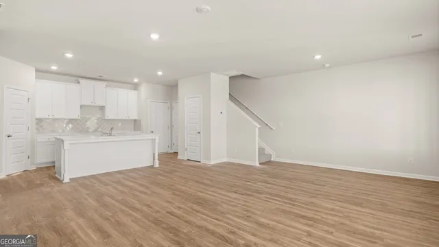 a view of a kitchen with wooden floor