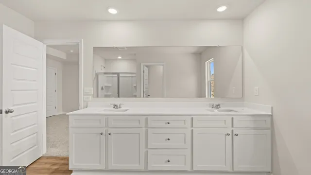 a bathroom with double sink and a mirror