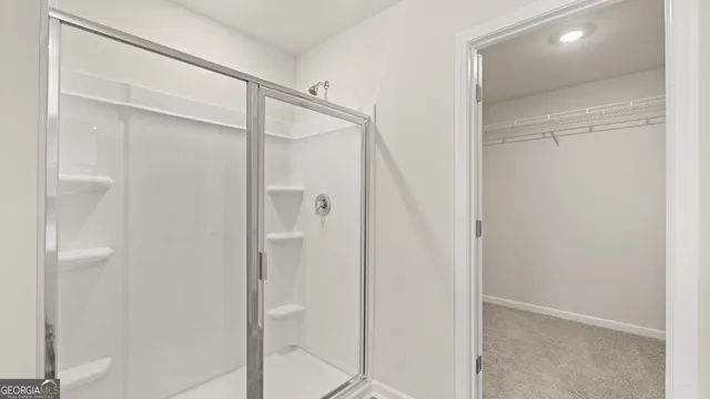 a bathroom with a glass shower door