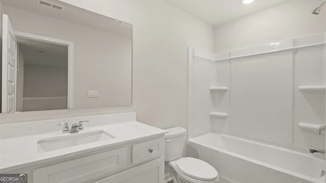 a bathroom with a bathtub shower sink vanity mirror and toilet