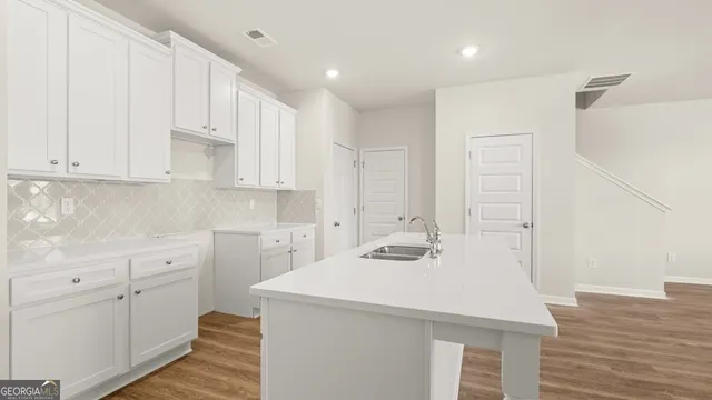 a kitchen with a sink a stove and cabinets