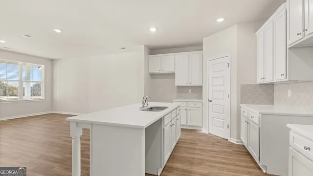 a kitchen with a sink stove and cabinets
