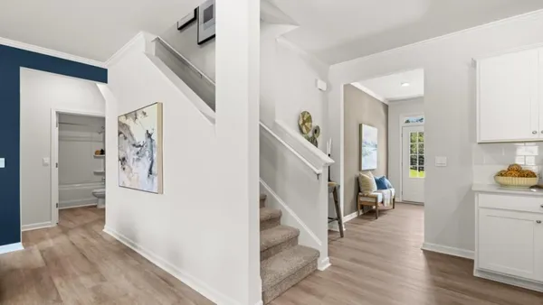 a view of a hallway view with wooden floor and staircase