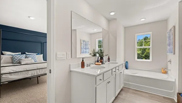 a bathroom with a sink double vanity and a bathtub