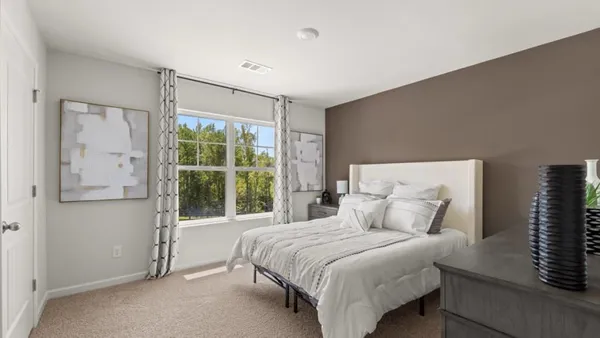 a bedroom with a large bed and a large window