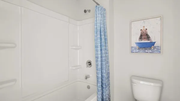 a bathroom with a shower a toilet and a sink