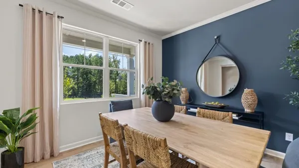 a view of a dining room with a table and chairs